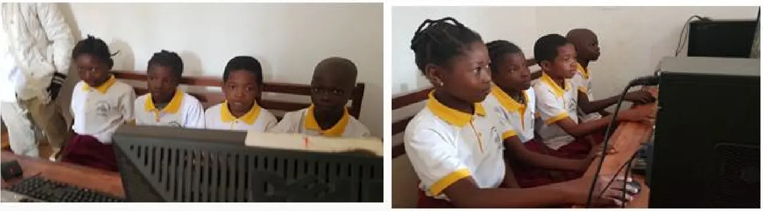 Élèves du complexe scolaire Sainte Joséphine devant les ordinateurs